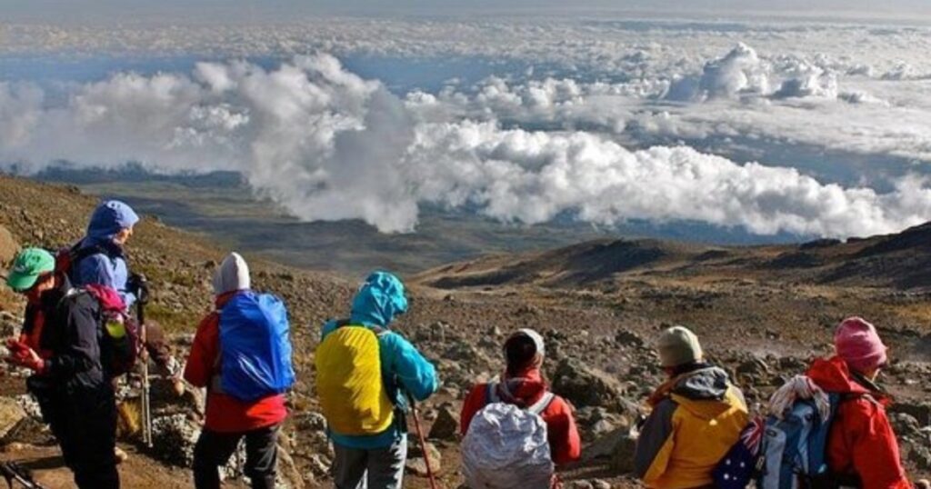 Clouds on top of the Kilimanjaro mountains, you will have this experience during your 6 days tour safari.